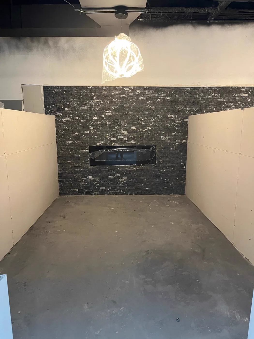 Stone feature wall with accent lighting in a finished commercial venue renovation, Metro Atlanta